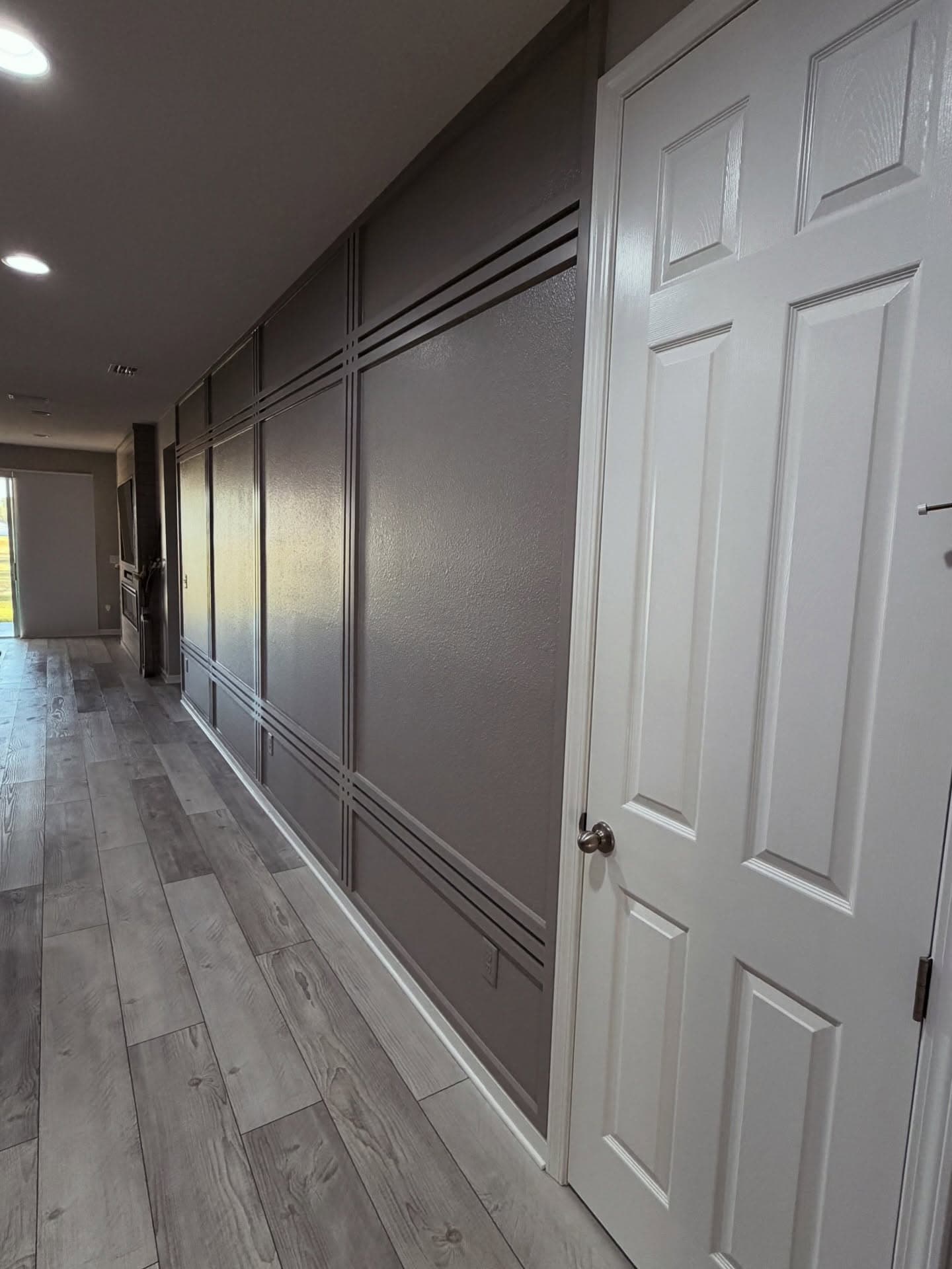 Hallway picture-frame moulding accent wall in gray by AVP Construction JAX
