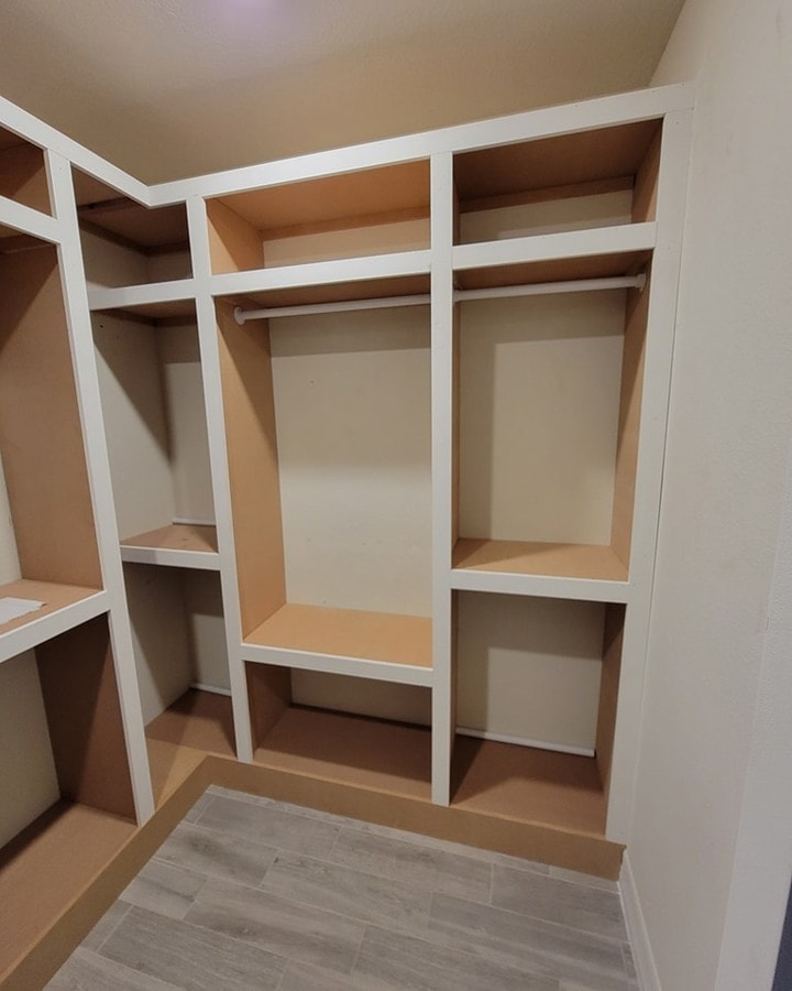 His-and-hers walk-in closet build-out, custom-built for the space, by AVP Construction JAX in Jacksonville & St. Johns County, FL