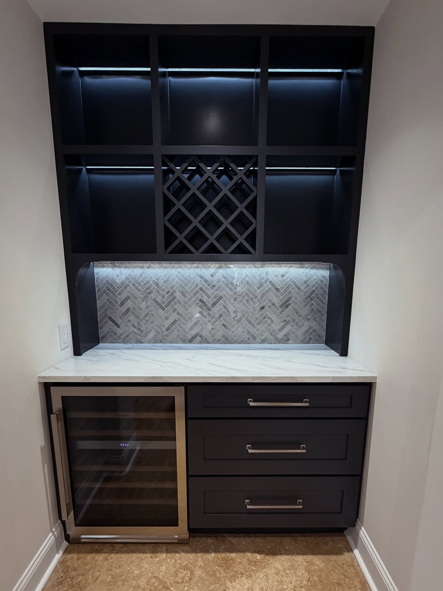 Compact dry bar tucked into a feature wall, custom-built for the space, by AVP Construction JAX in Jacksonville & St. Johns County, FL