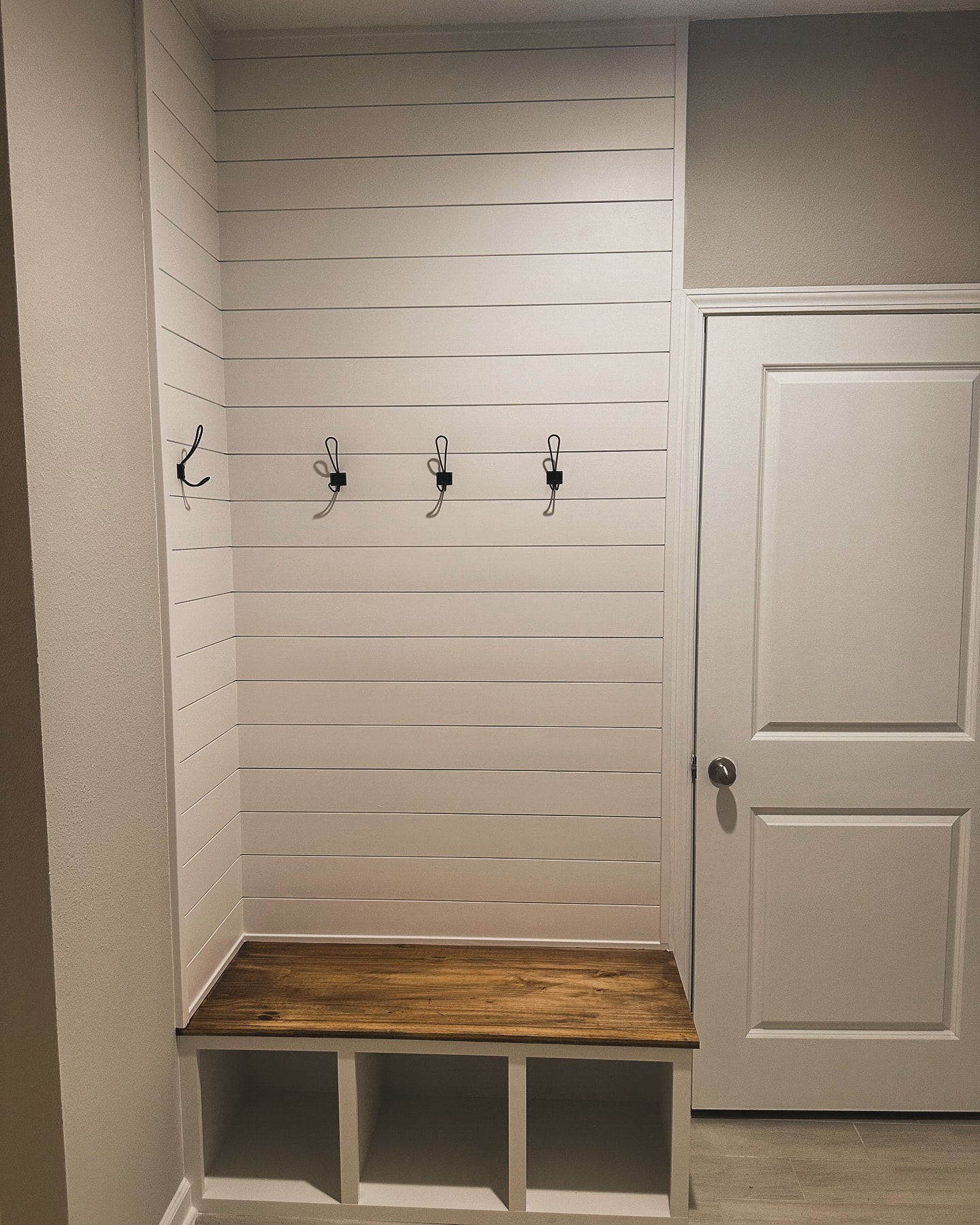Custom mudroom with shoe storage and bench, custom-built for the space, by AVP Construction JAX in Jacksonville & St. Johns County, FL