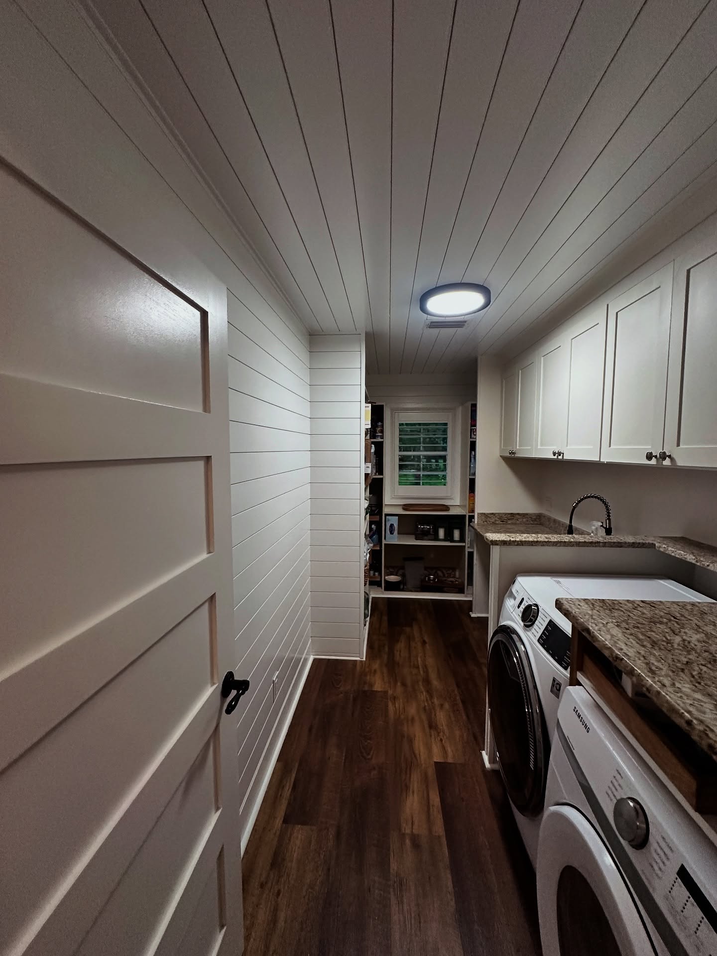 Laundry room millwork with upper cabinets, custom-built for the space, by AVP Construction JAX in Jacksonville & St. Johns County, FL