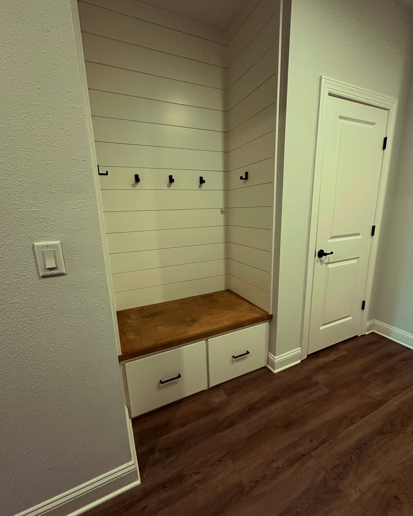 Mudroom built-in with overhead shelf, custom-built for the space, by AVP Construction JAX in Jacksonville & St. Johns County, FL