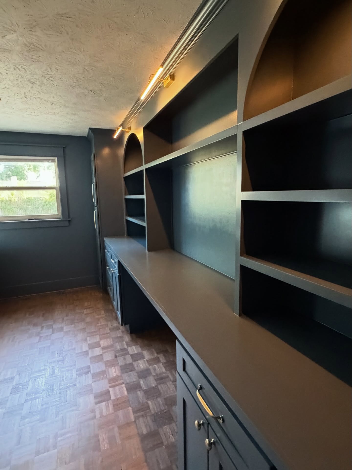 Library-style home office millwork, custom-built for the space, by AVP Construction JAX in Jacksonville & St. Johns County, FL