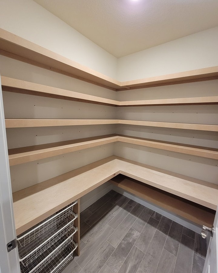 Custom pantry door and interior shelving, custom-built for the space, by AVP Construction JAX in Jacksonville & St. Johns County, FL