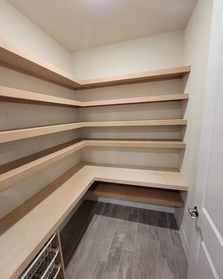 Hidden pantry with custom panel front, custom-built for the space, by AVP Construction JAX in Jacksonville & St. Johns County, FL
