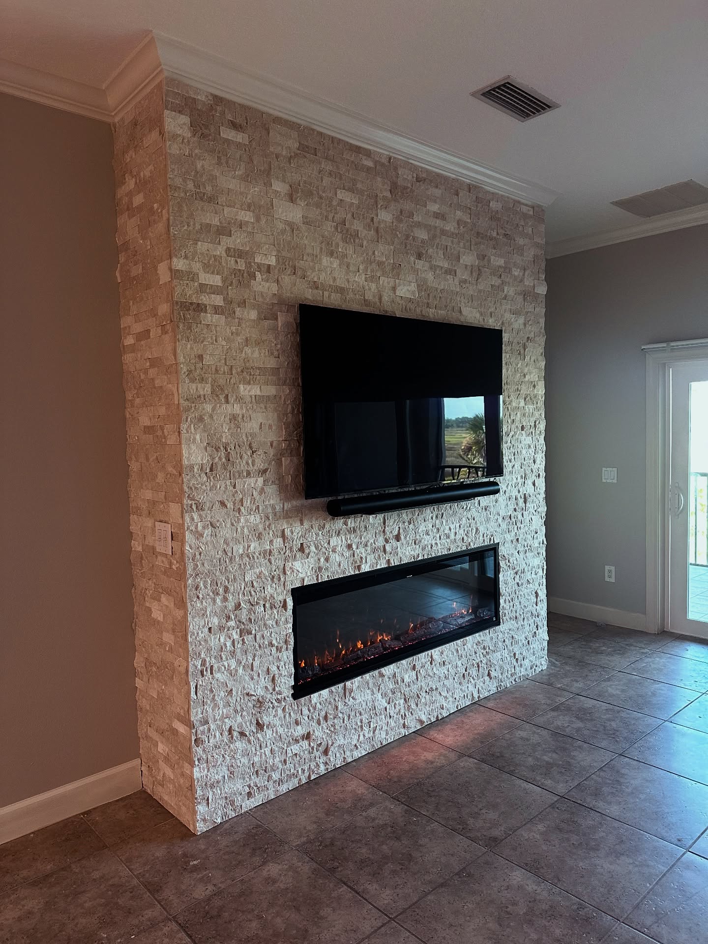 Wall-mounted TV with under-cabinet storage, custom-built for the space, by AVP Construction JAX in Jacksonville & St. Johns County, FL