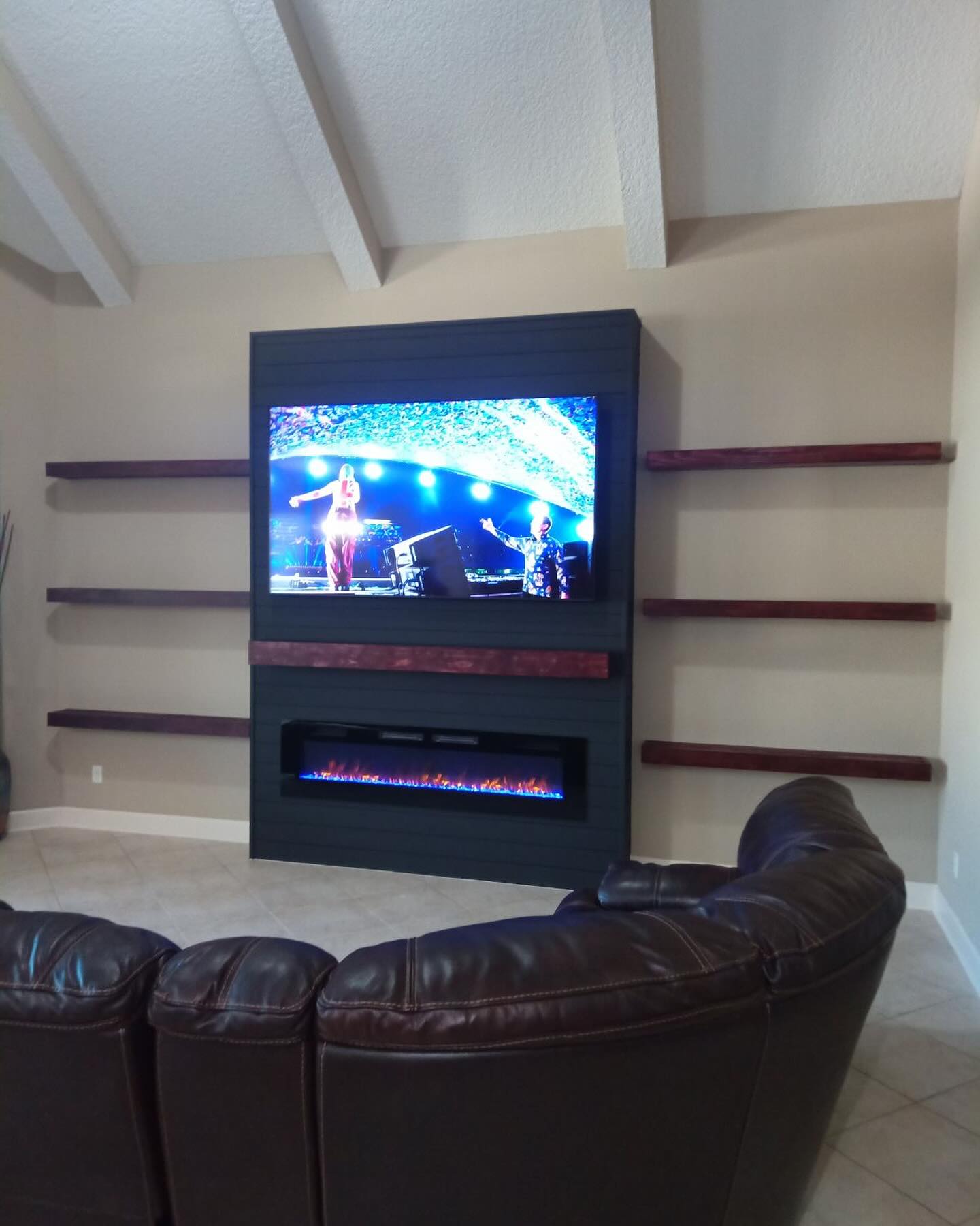 Modern entertainment center with electric fireplace, custom-built for the space, by AVP Construction JAX in Jacksonville & St. Johns County, FL