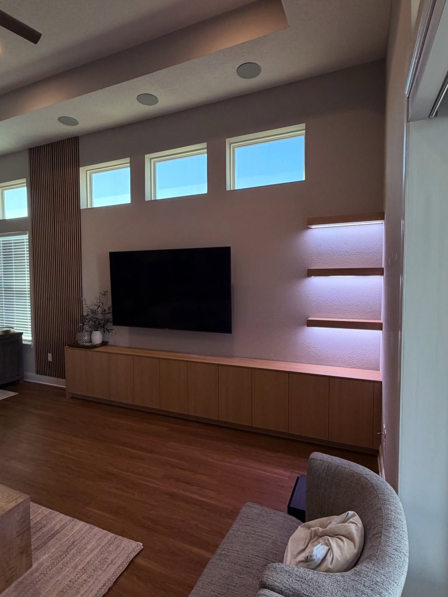 Custom living-room media wall with paneling, custom-built for the space, by AVP Construction JAX in Jacksonville & St. Johns County, FL