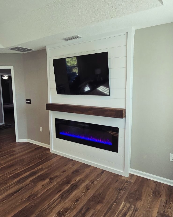 Slat-wall TV feature with hidden wiring, custom-built for the space, by AVP Construction JAX in Jacksonville & St. Johns County, FL