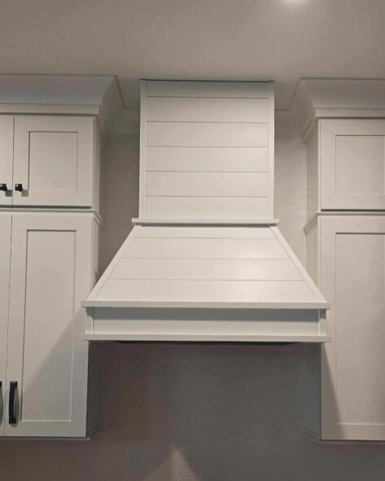 Painted custom hood vent over island, custom-built for the space, by AVP Construction JAX in Jacksonville & St. Johns County, FL