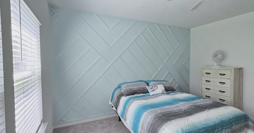 Floor-to-ceiling slat accent wall by AVP Construction JAX — Jacksonville & St. John's County, FL