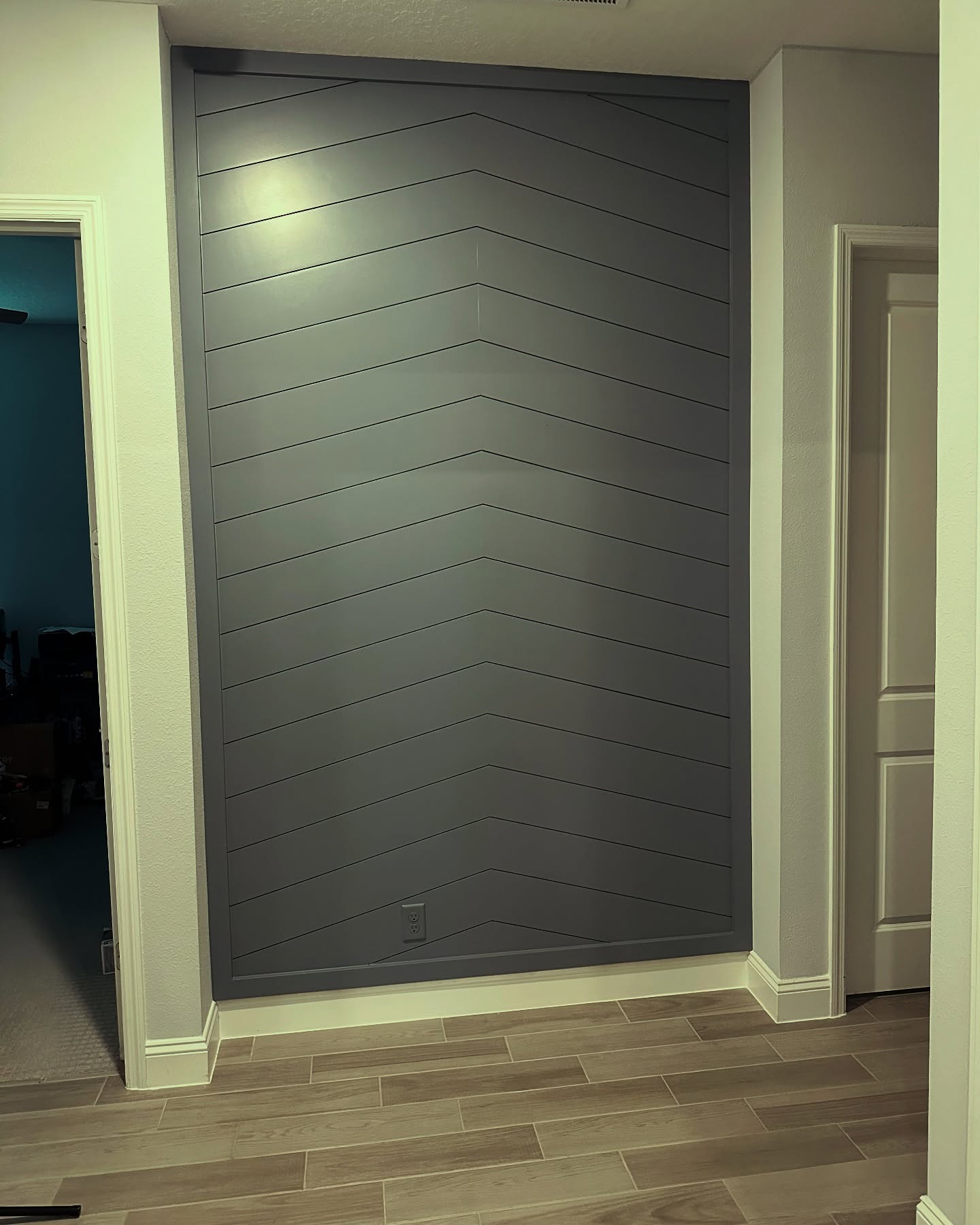 Floor-to-ceiling slat accent wall by AVP Construction JAX — Jacksonville & St. John's County, FL