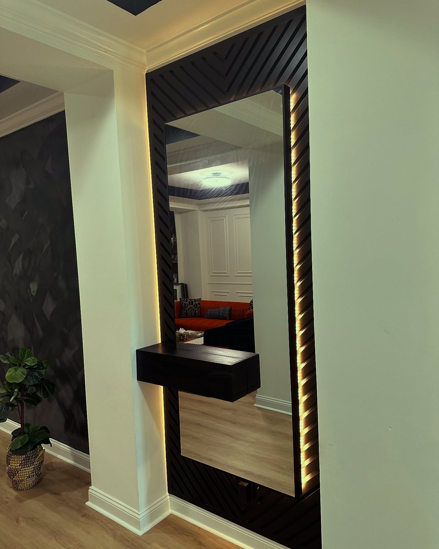 Floor-to-ceiling slat accent wall by AVP Construction JAX — Jacksonville & St. John's County, FL