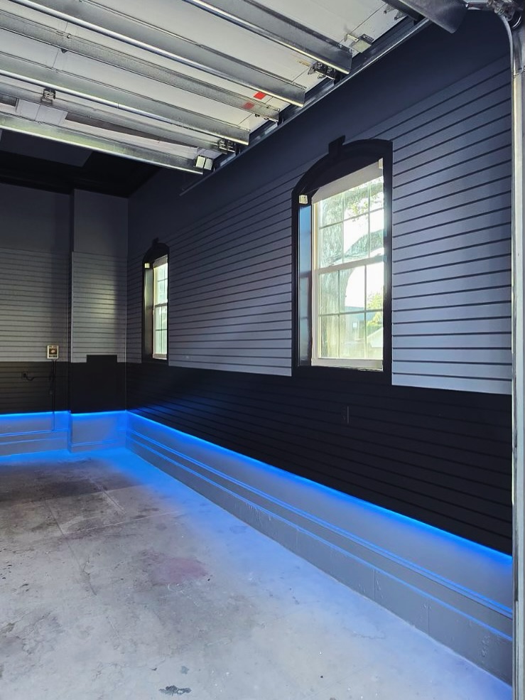 Floor-to-ceiling slat accent wall by AVP Construction JAX — Jacksonville & St. John's County, FL