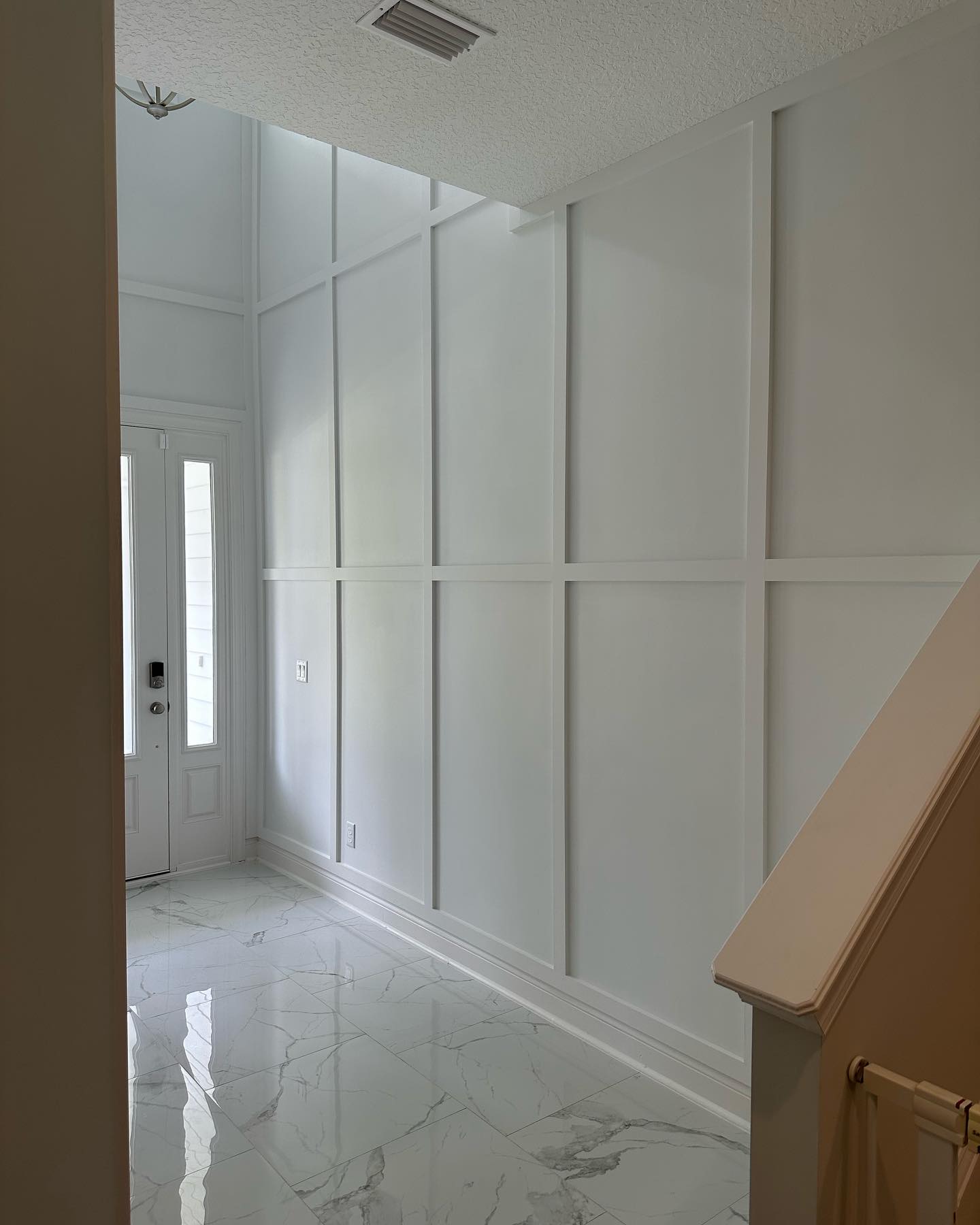 Floor-to-ceiling slat accent wall by AVP Construction JAX — Jacksonville & St. John's County, FL
