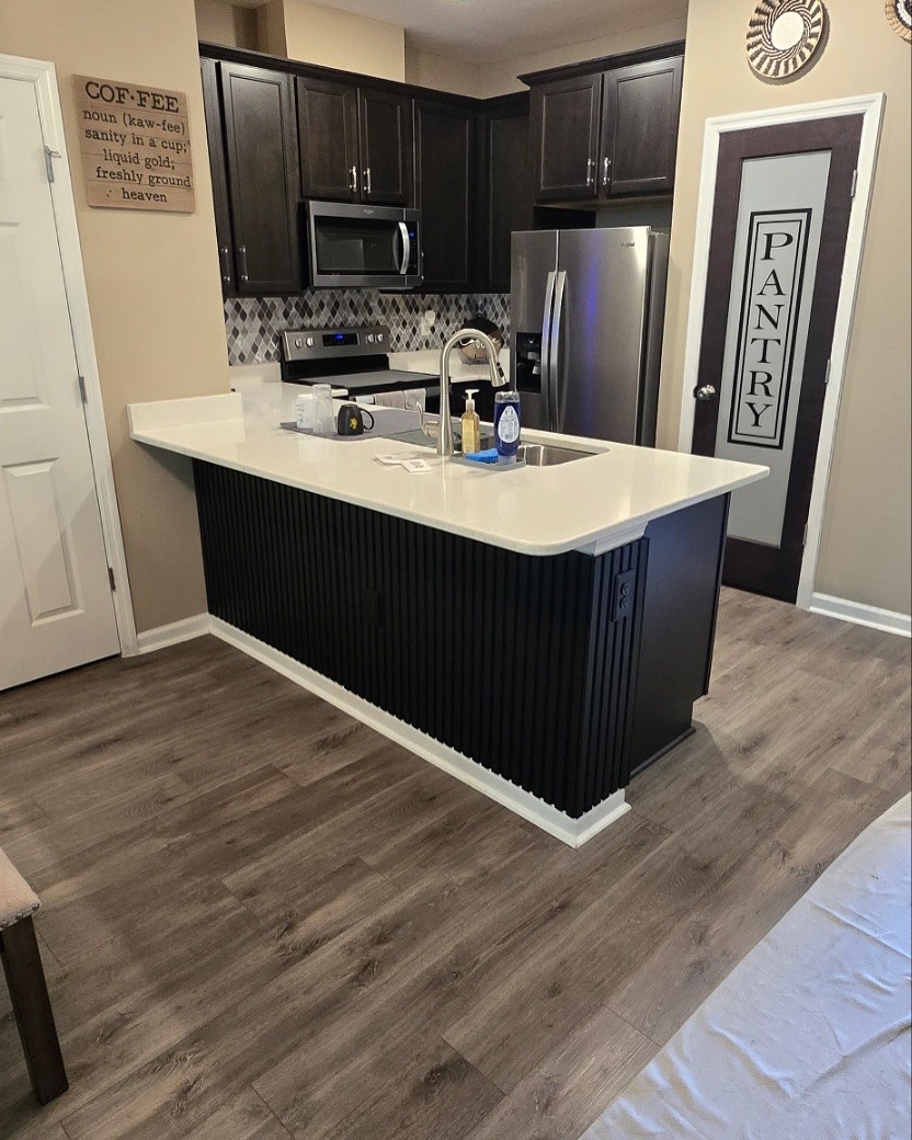 Floor-to-ceiling slat accent wall by AVP Construction JAX — Jacksonville & St. John's County, FL