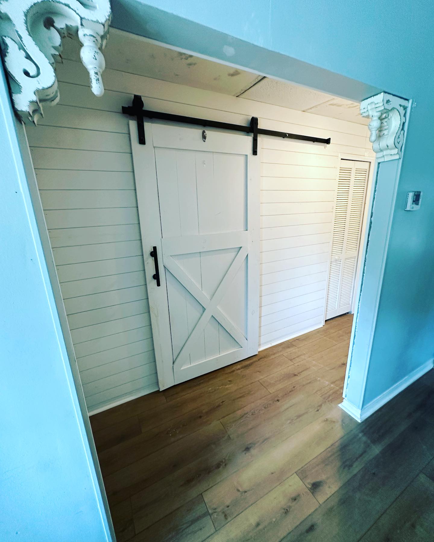 Statement bedroom accent wall in white shiplap by AVP Construction JAX — Jacksonville & St. John's County, FL