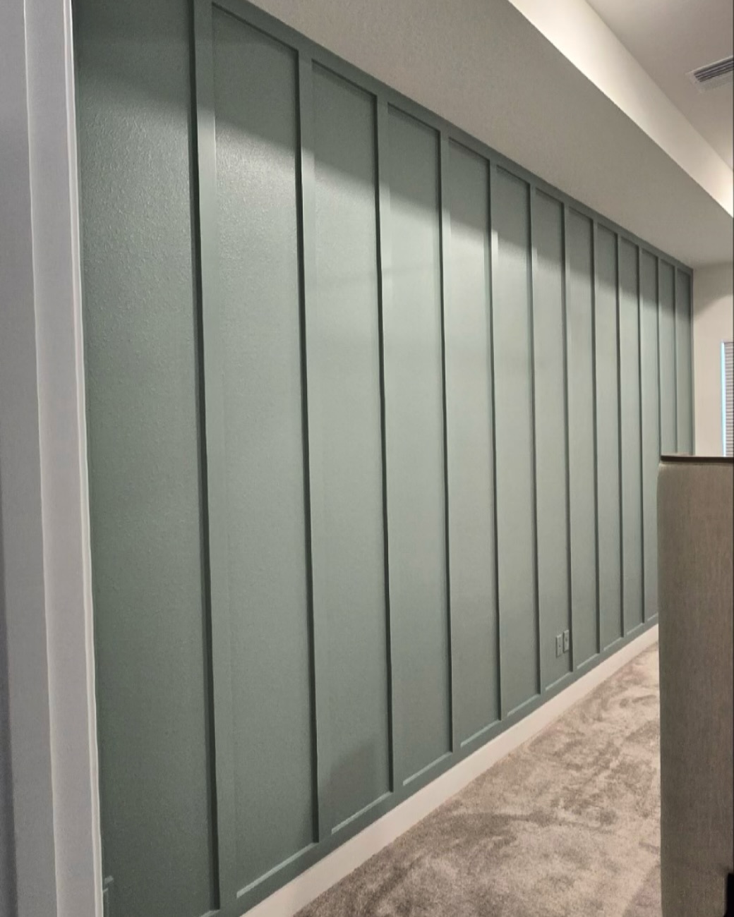 Vertical slat wood accent wall by AVP Construction JAX — Jacksonville & St. John's County, FL