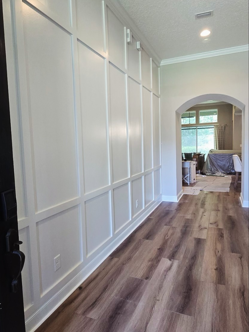 Floor-to-ceiling slat accent wall by AVP Construction JAX — Jacksonville & St. John's County, FL