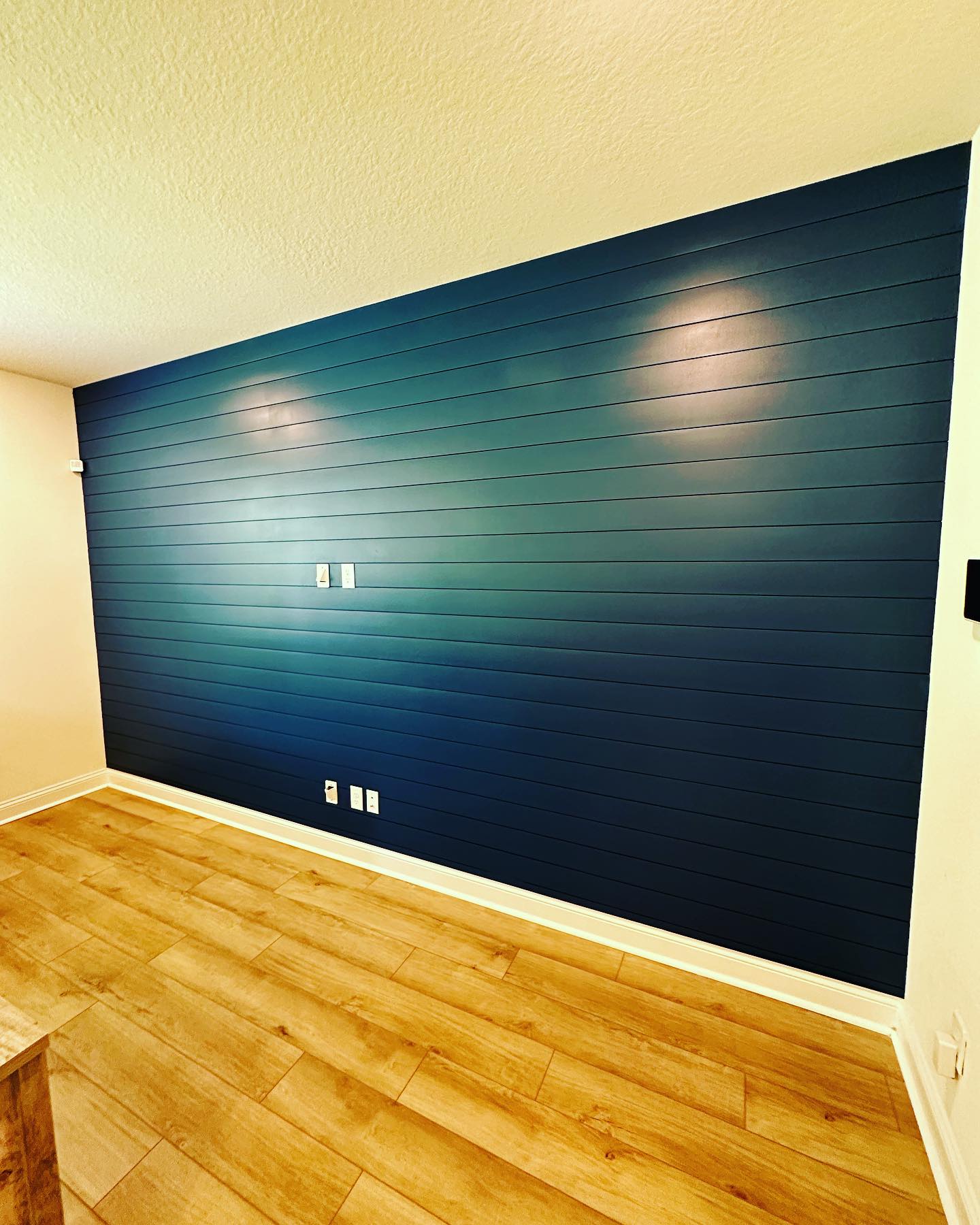 Statement bedroom accent wall in white shiplap by AVP Construction JAX — Jacksonville & St. John's County, FL