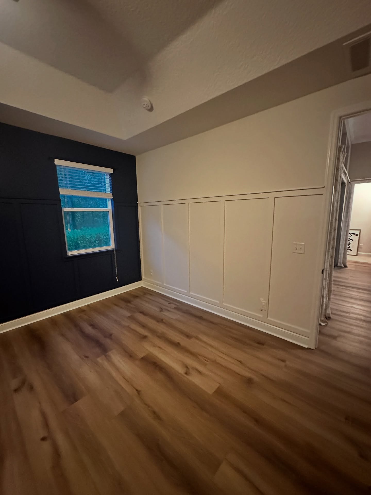 Floor-to-ceiling slat accent wall by AVP Construction JAX — Jacksonville & St. John's County, FL