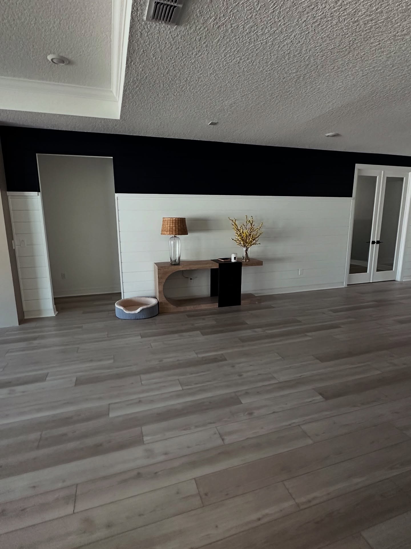 Floor-to-ceiling slat accent wall by AVP Construction JAX — Jacksonville & St. John's County, FL