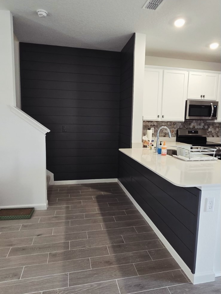 Modern fluted wood accent wall by AVP Construction JAX — Jacksonville & St. John's County, FL