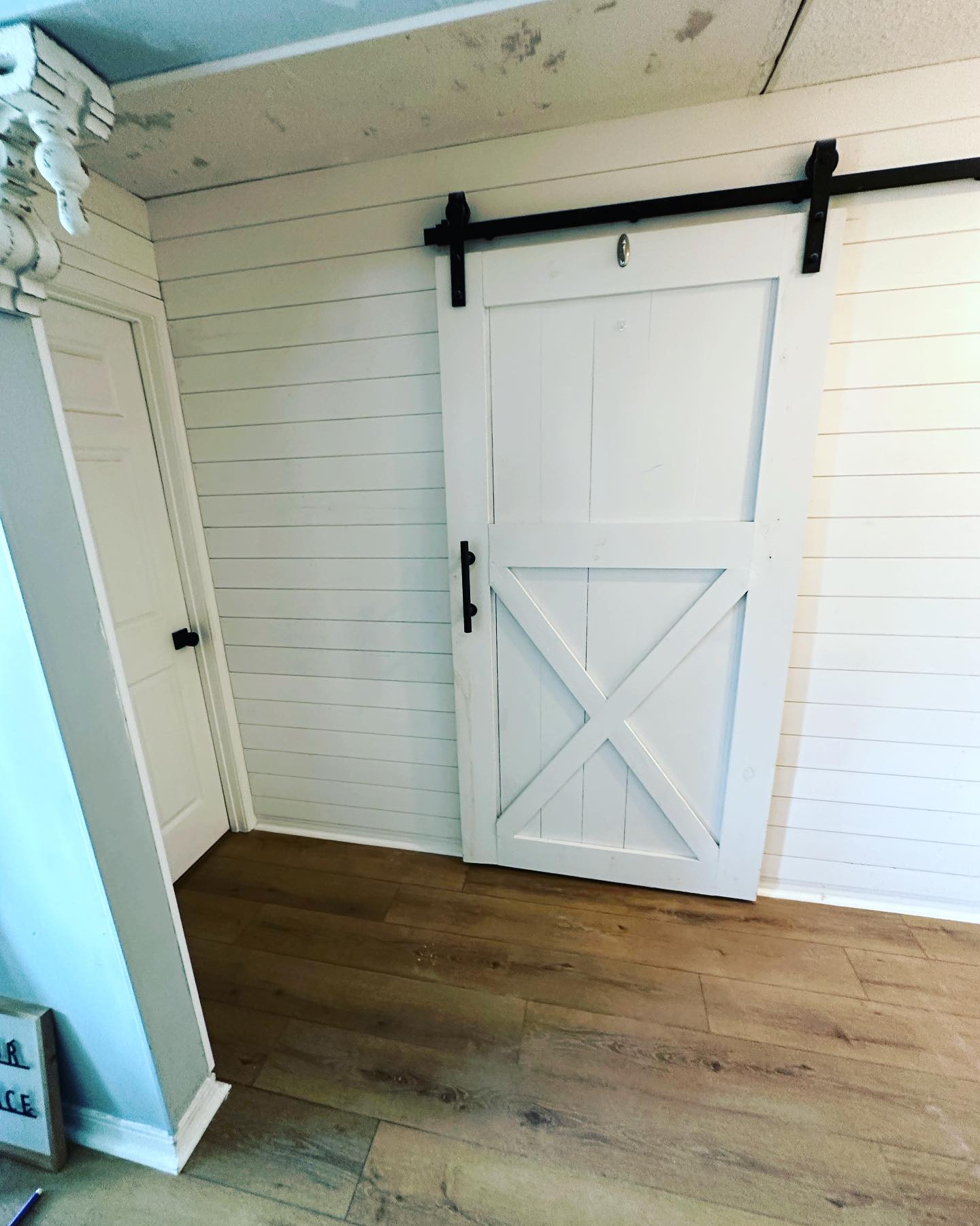 Floor-to-ceiling slat accent wall by AVP Construction JAX — Jacksonville & St. John's County, FL