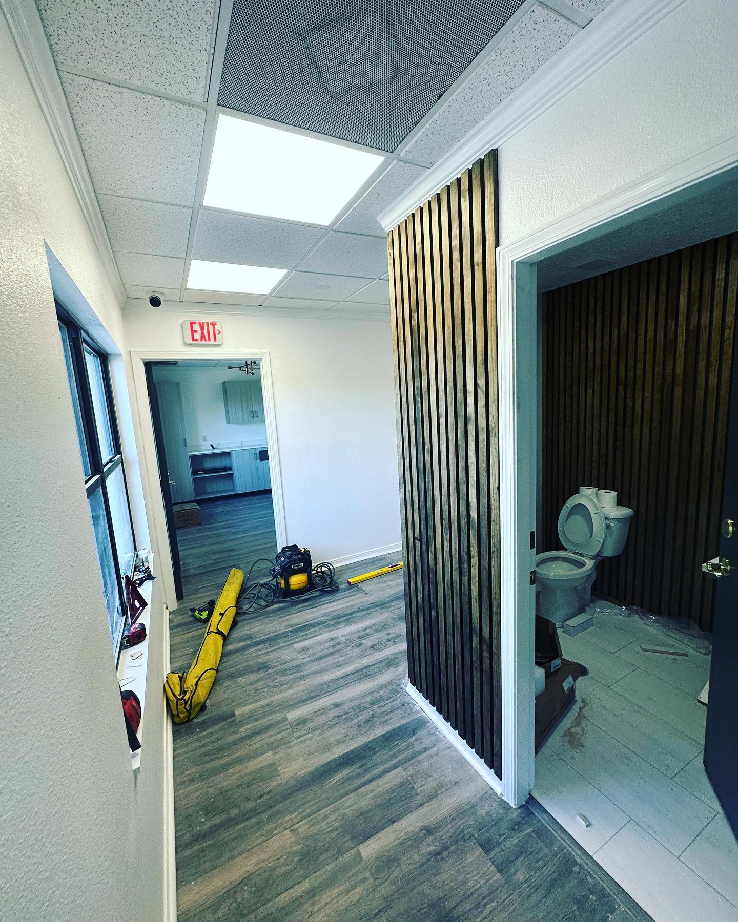 Modern fluted wood accent wall by AVP Construction JAX — Jacksonville & St. John's County, FL