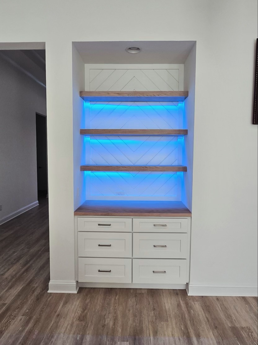 Compact dry bar tucked into a feature wall by AVP Construction JAX — Jacksonville & St. John's County, FL