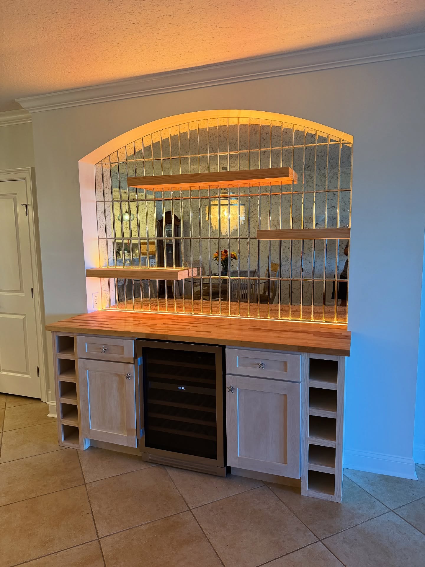 Custom liquor bar with glass-front cabinets by AVP Construction JAX — Jacksonville & St. John's County, FL