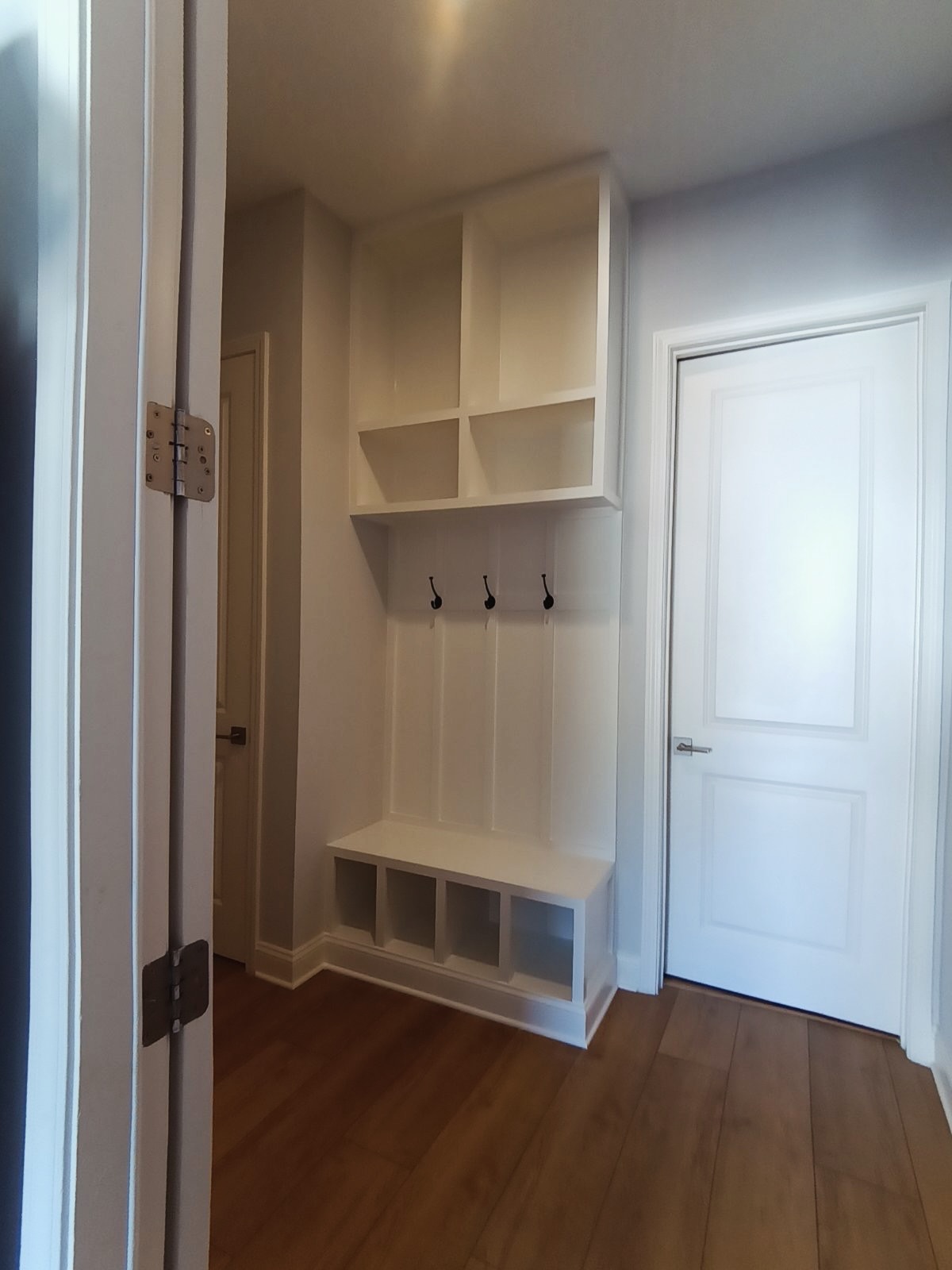 Custom mudroom built-in with bench and hooks by AVP Construction JAX — Jacksonville & St. John's County, FL