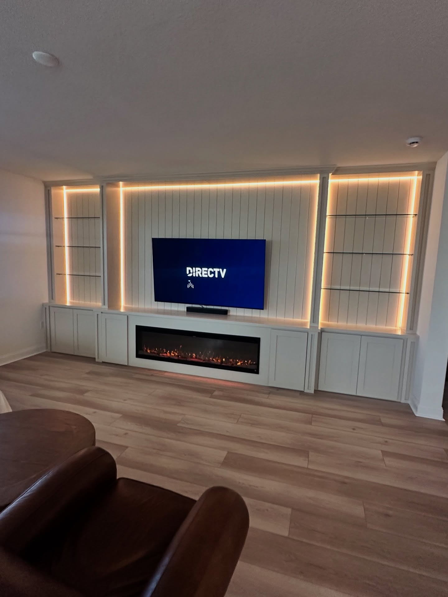 Floating-shelf TV built-in with shaker cabinets by AVP Construction JAX — Jacksonville & St. John's County, FL