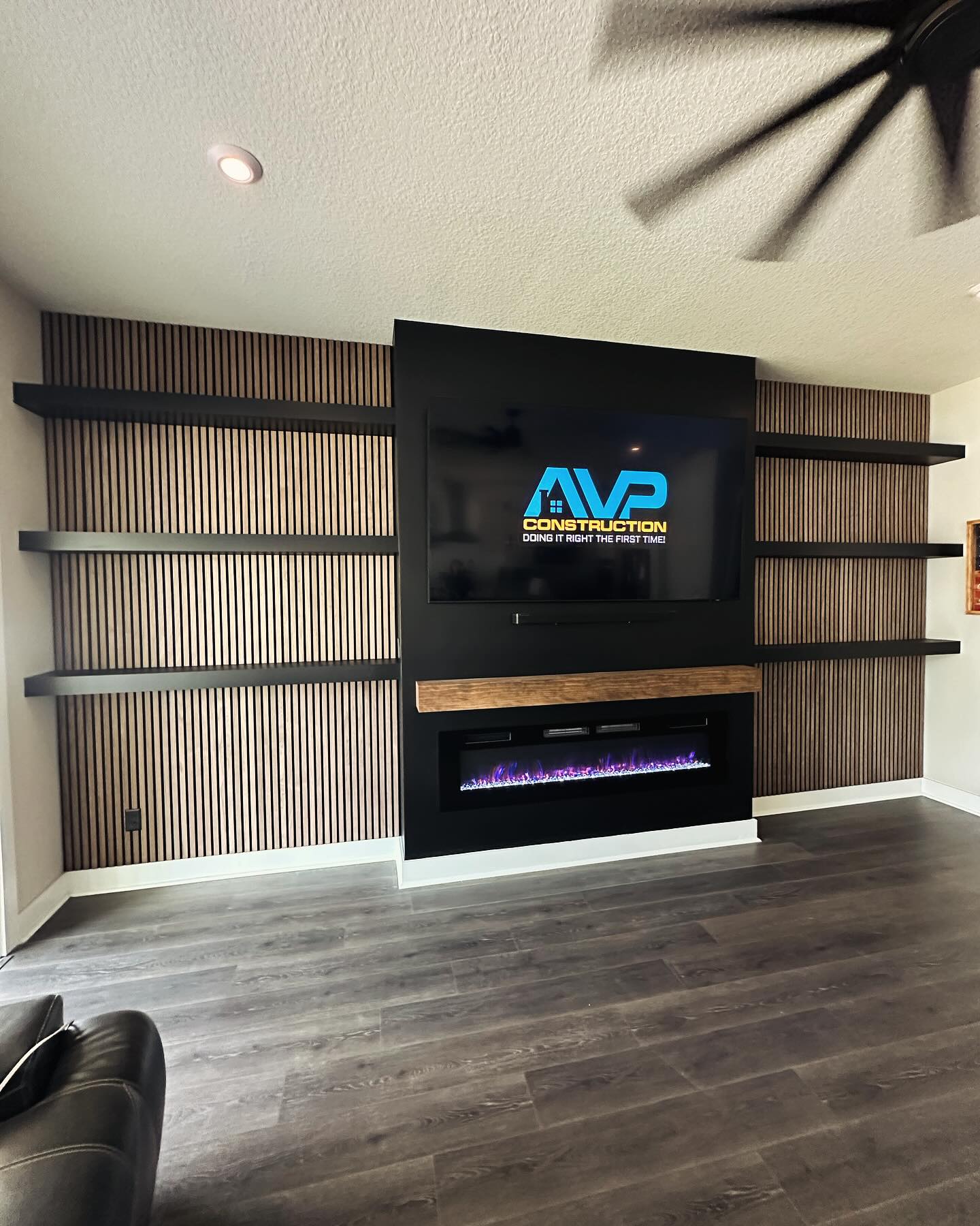 Wall-mounted TV with under-cabinet storage by AVP Construction JAX — Jacksonville & St. John's County, FL