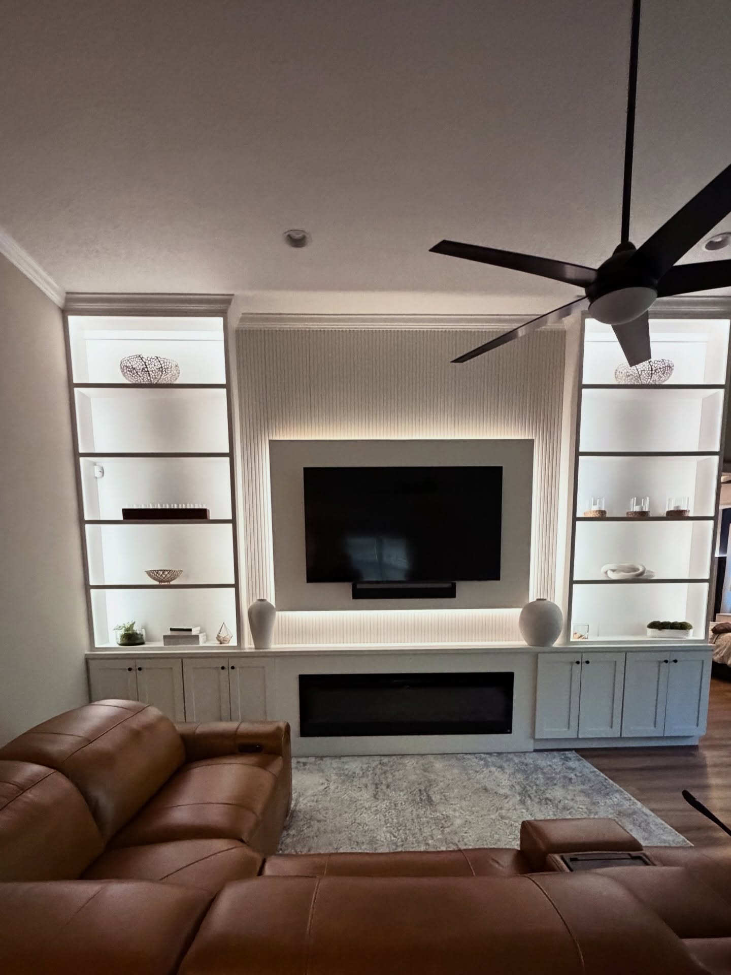 Built-in TV cabinet flanked by display shelving by AVP Construction JAX — Jacksonville & St. John's County, FL