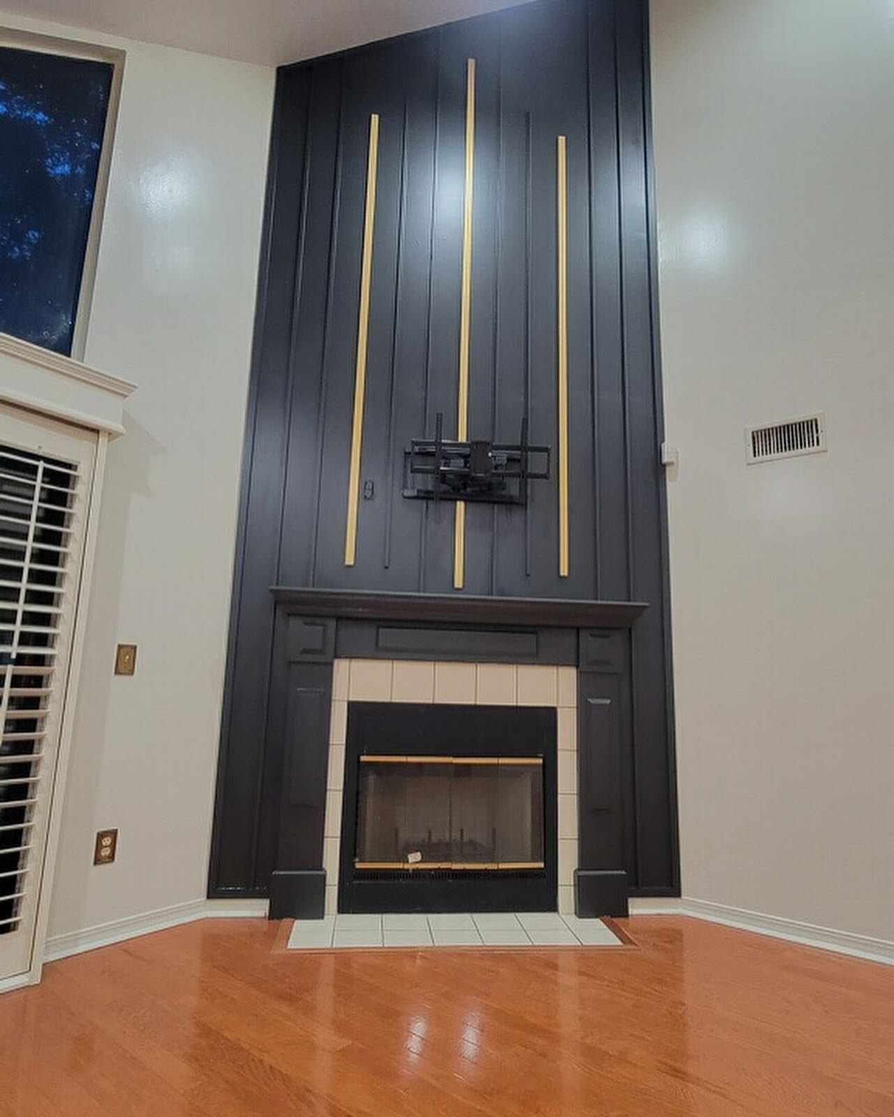 Custom living-room media wall with paneling by AVP Construction JAX — Jacksonville & St. John's County, FL