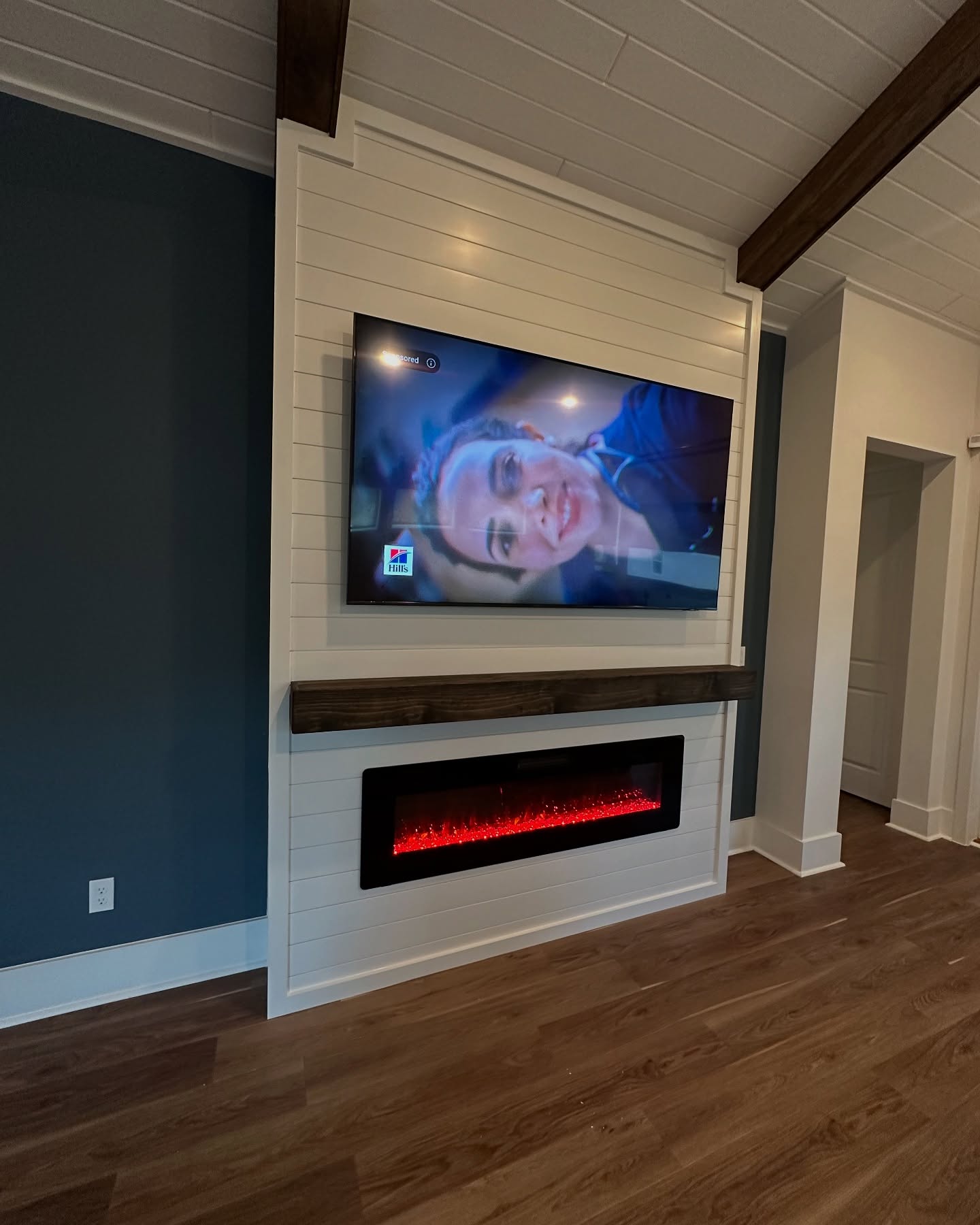 Wall-mounted TV with under-cabinet storage by AVP Construction JAX — Jacksonville & St. John's County, FL