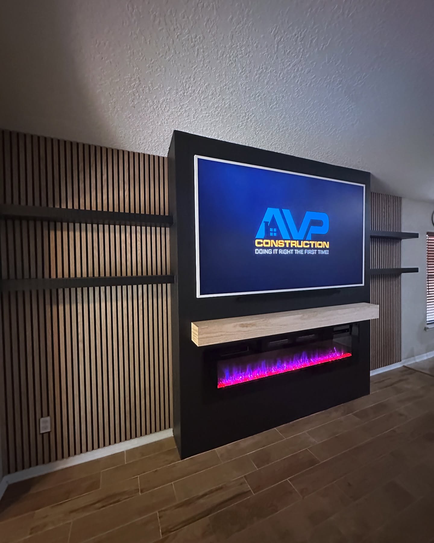 Modern entertainment center with electric fireplace by AVP Construction JAX — Jacksonville & St. John's County, FL