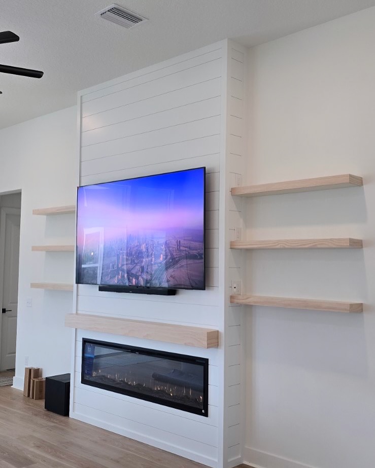 Built-in TV cabinet flanked by display shelving by AVP Construction JAX — Jacksonville & St. John's County, FL