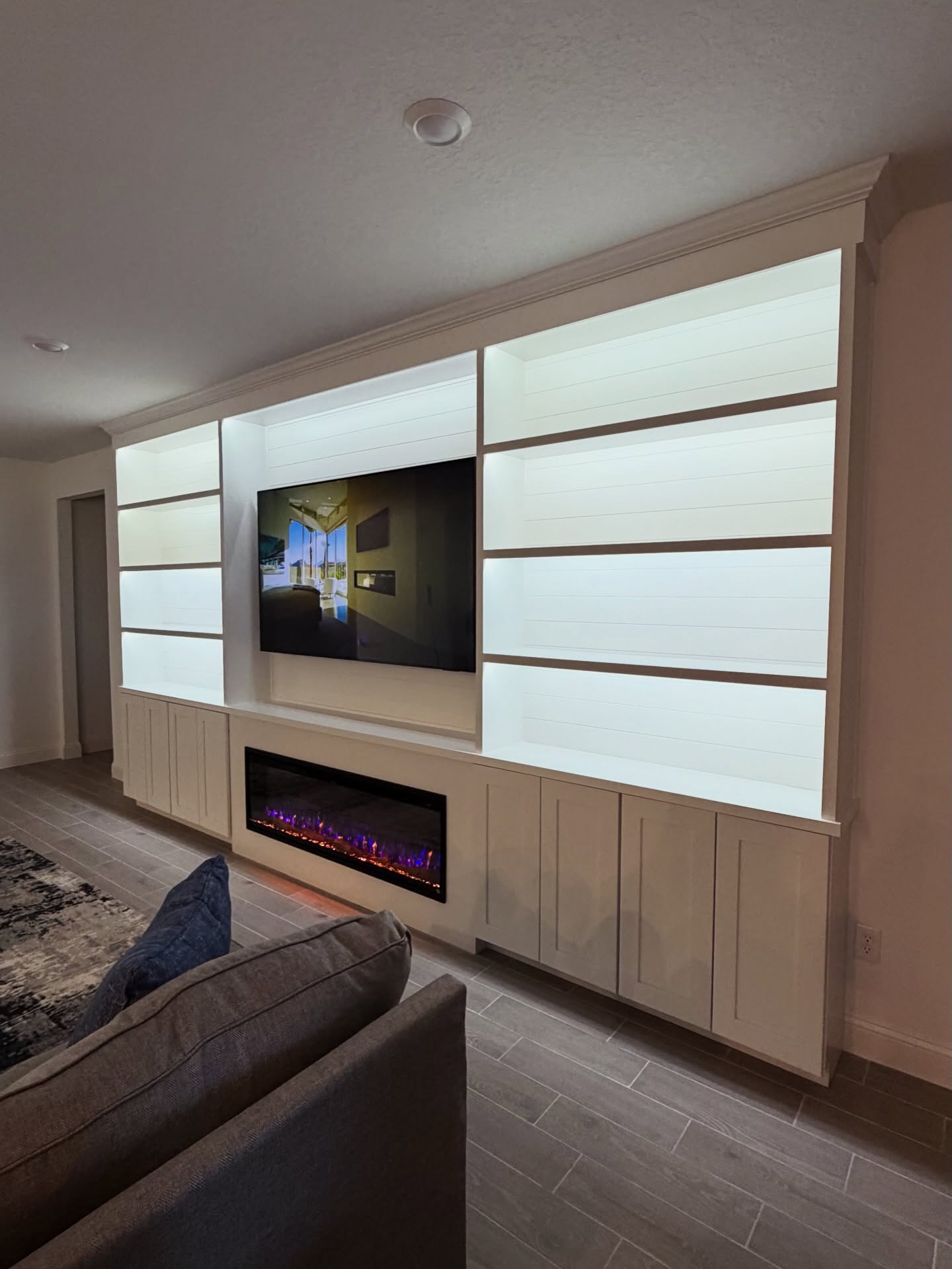 Custom living-room media wall with paneling by AVP Construction JAX — Jacksonville & St. John's County, FL