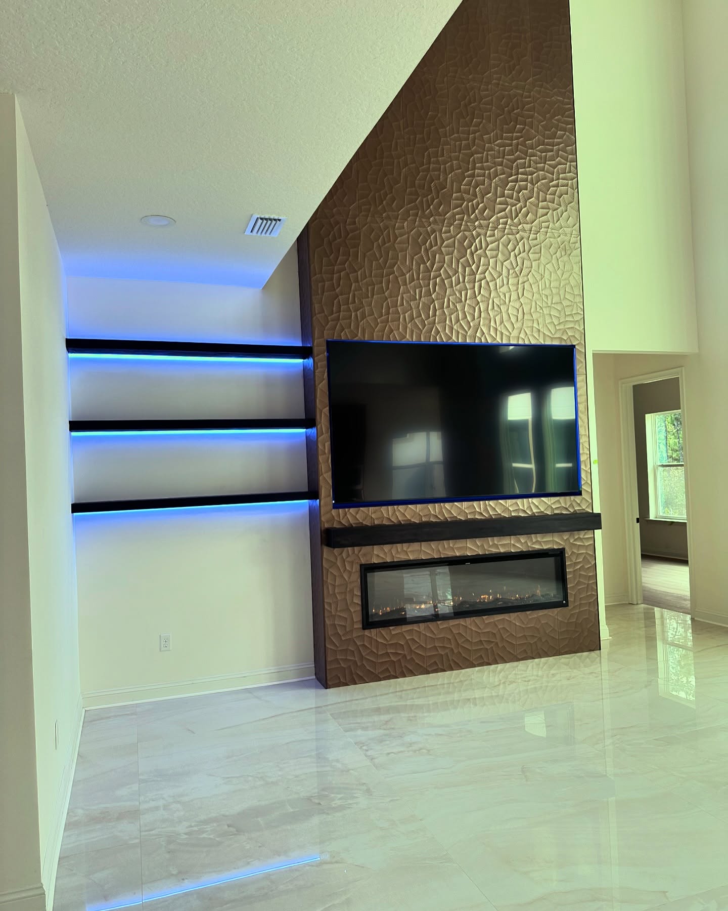 Floor-to-ceiling media wall with custom millwork by AVP Construction JAX — Jacksonville & St. John's County, FL