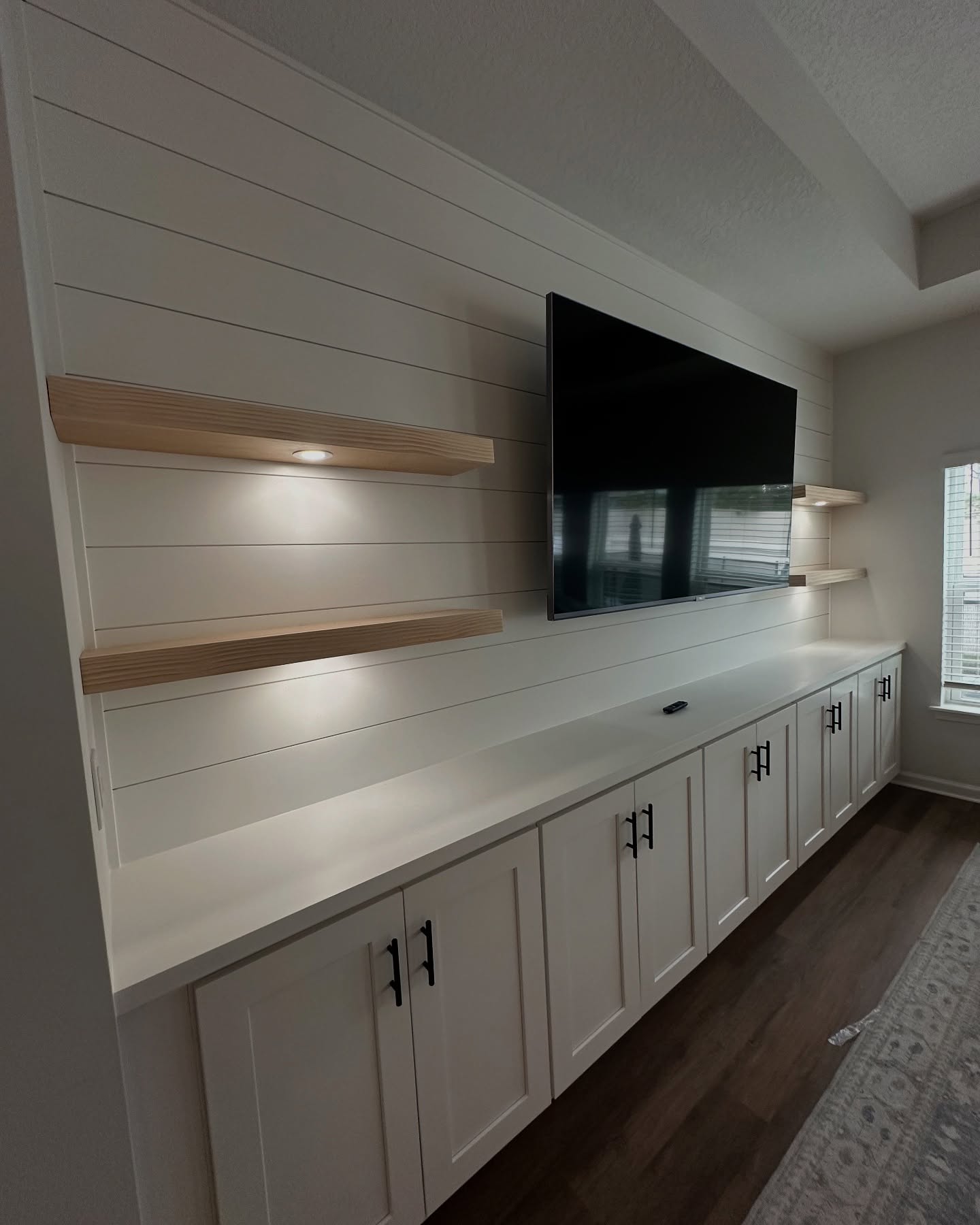 Custom living-room media wall with paneling by AVP Construction JAX — Jacksonville & St. John's County, FL