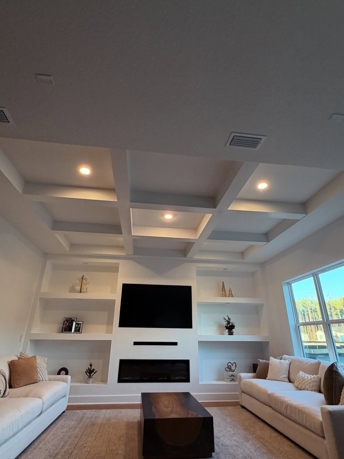 Floor-to-ceiling media wall with custom millwork by AVP Construction JAX — Jacksonville & St. John's County, FL