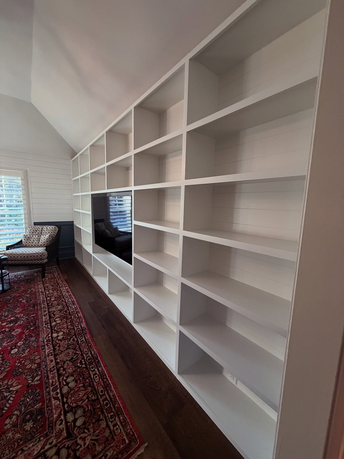 Floating-shelf TV built-in with shaker cabinets by AVP Construction JAX — Jacksonville & St. John's County, FL