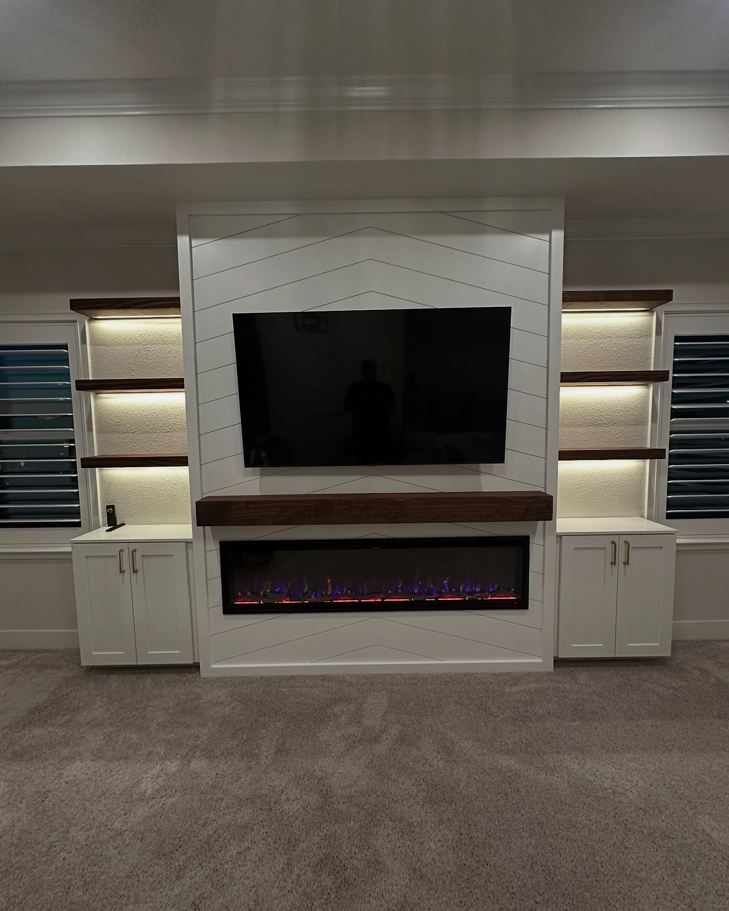 Modern entertainment center with electric fireplace by AVP Construction JAX — Jacksonville & St. John's County, FL