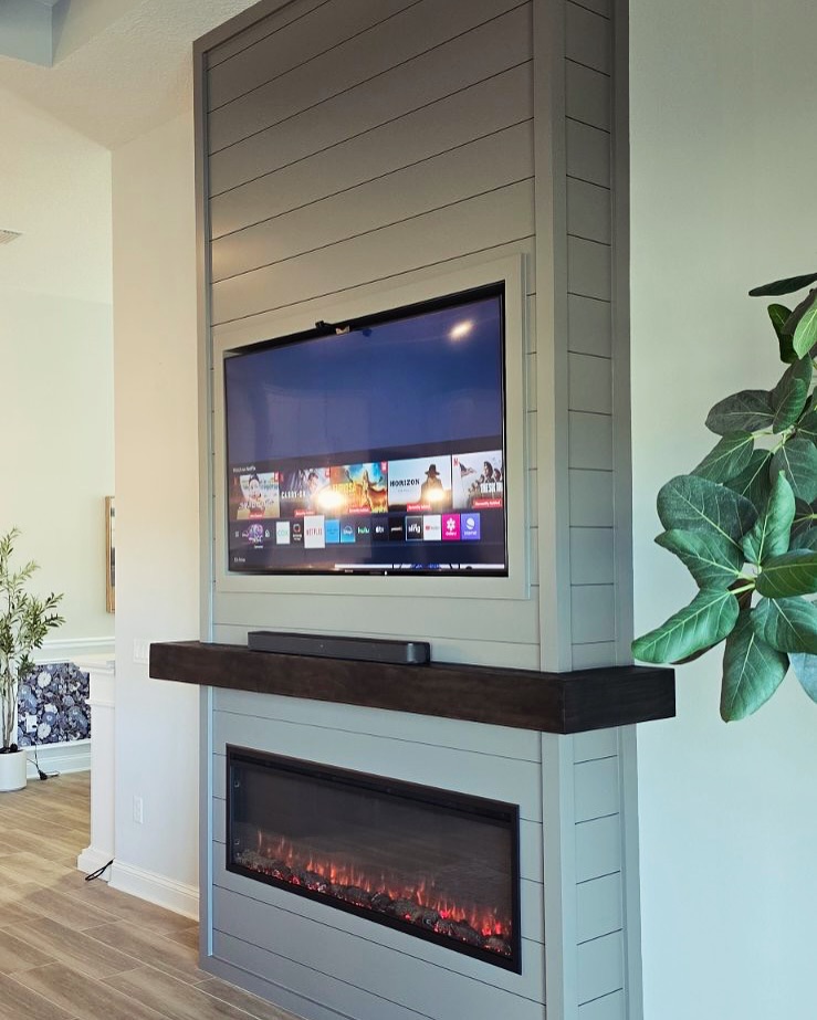 Built-in TV cabinet flanked by display shelving by AVP Construction JAX — Jacksonville & St. John's County, FL