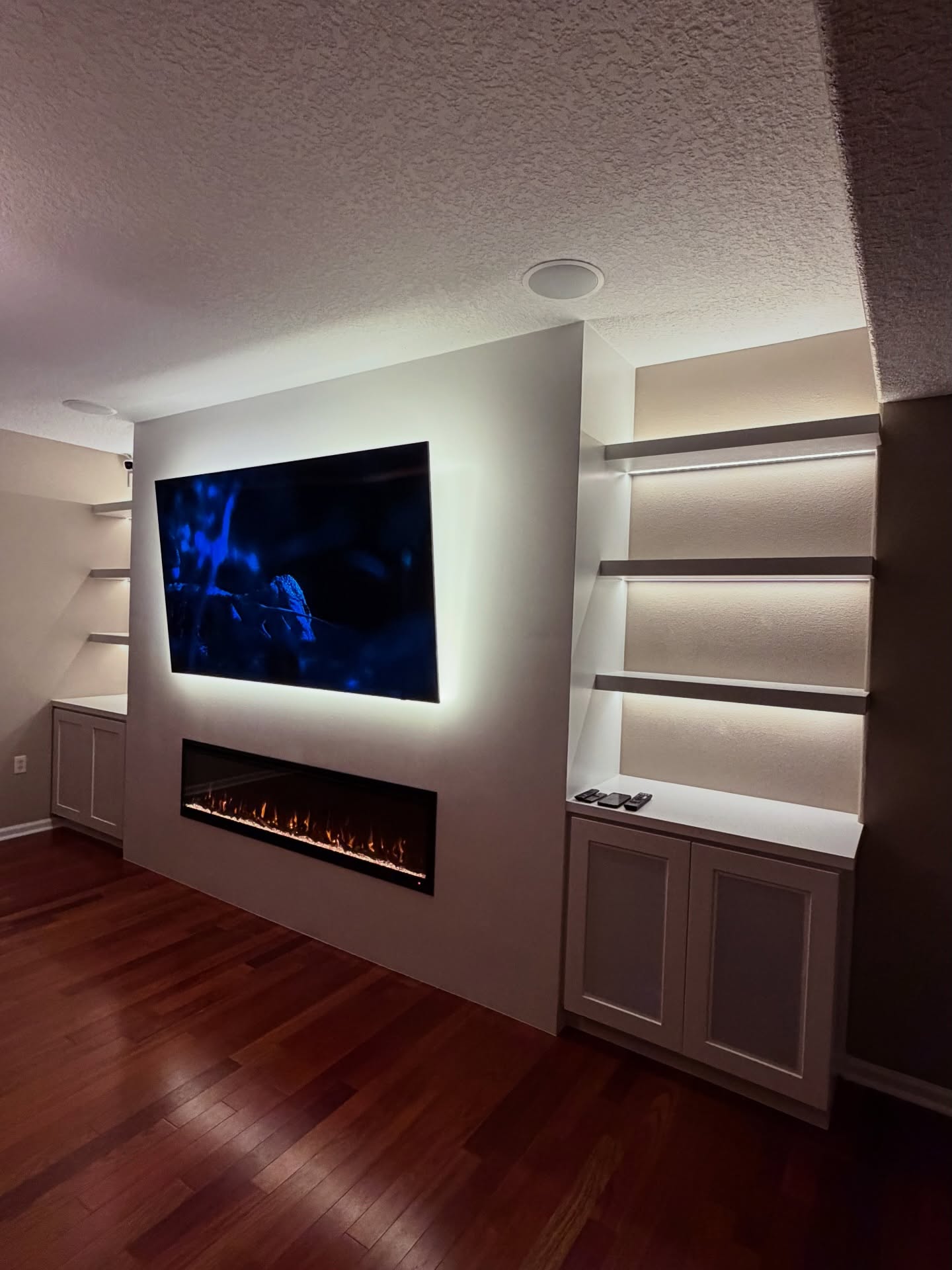 Wall-mounted TV with under-cabinet storage by AVP Construction JAX — Jacksonville & St. John's County, FL