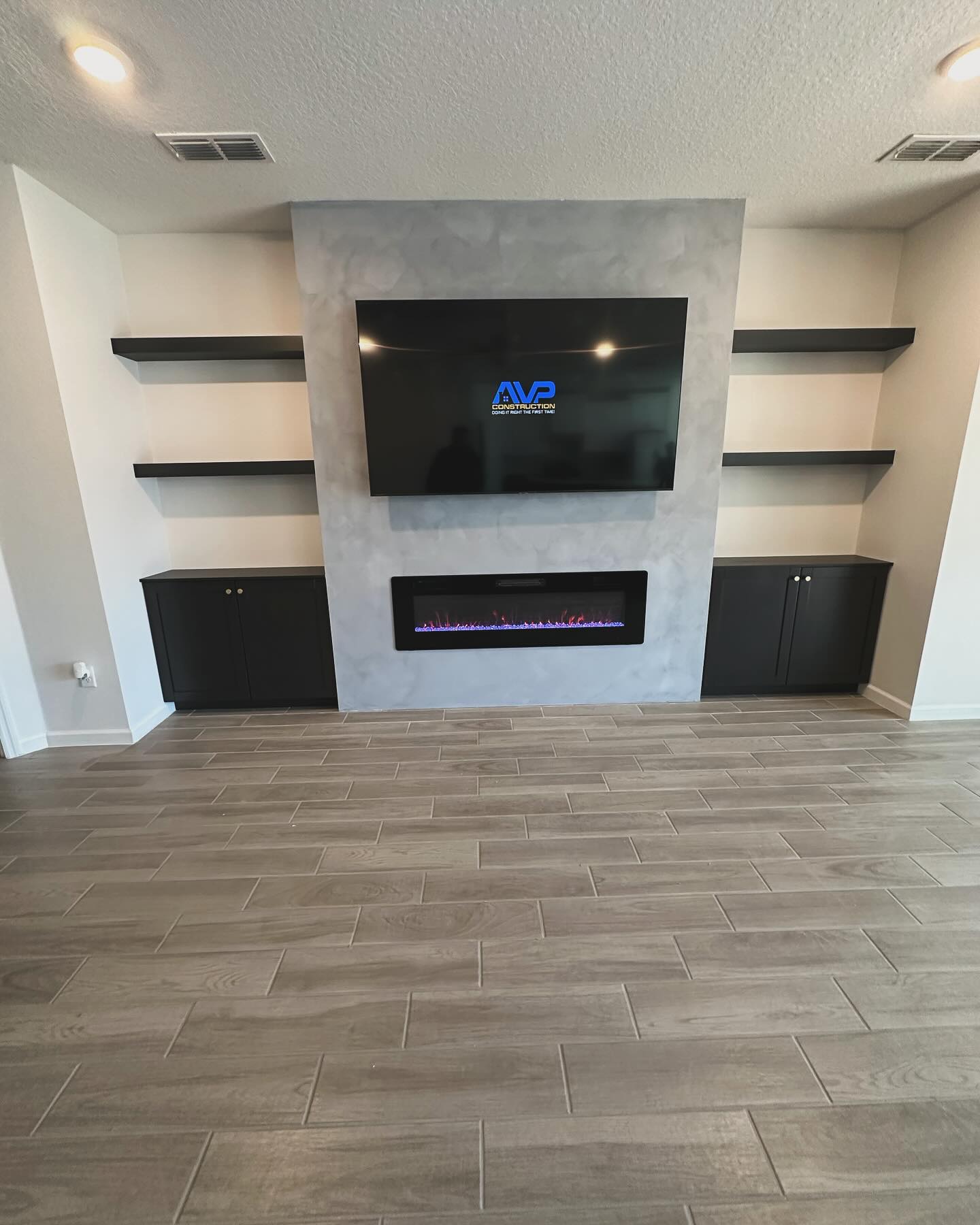 Slat-wall TV feature with hidden wiring by AVP Construction JAX — Jacksonville & St. John's County, FL
