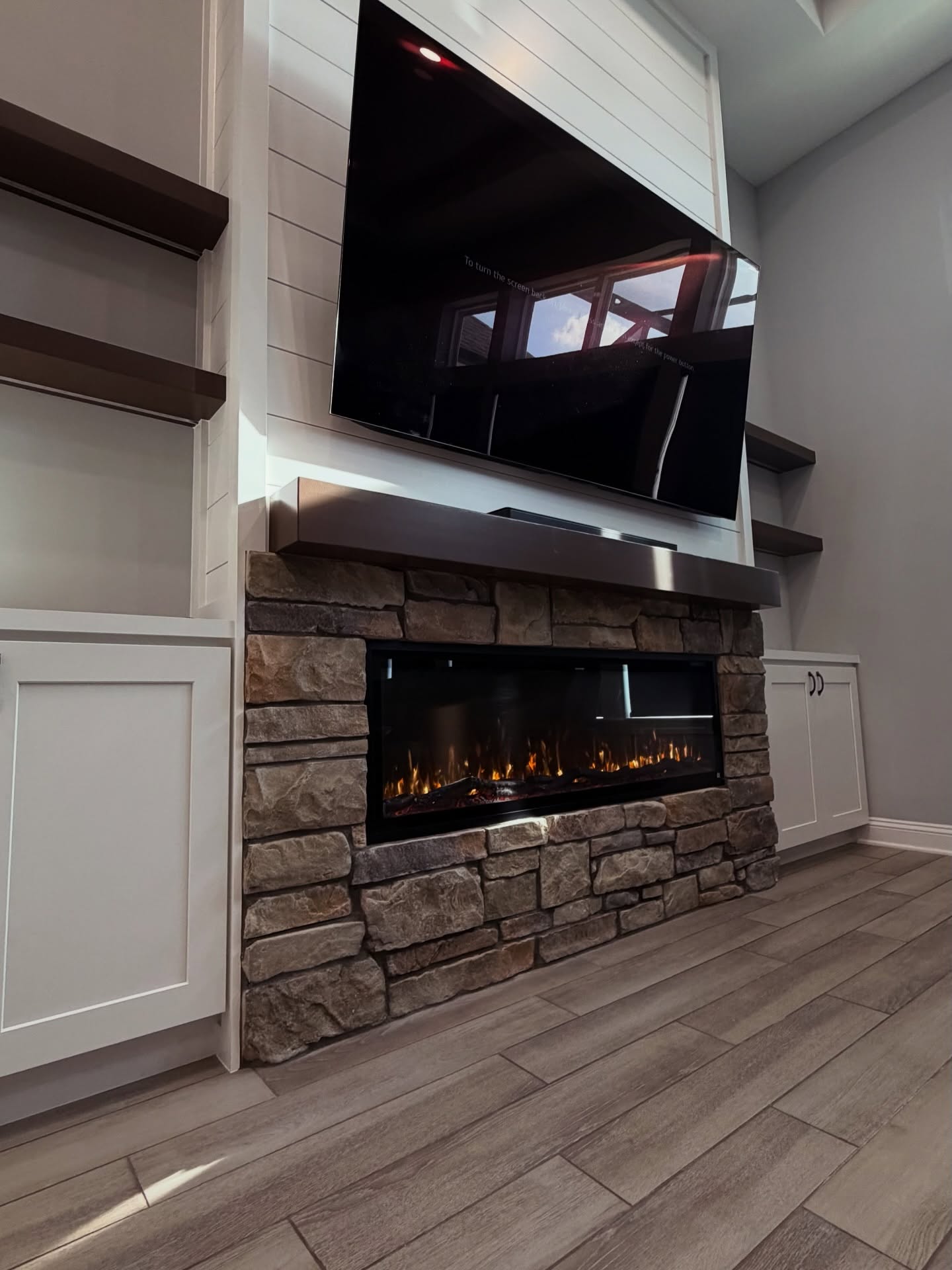 Wall-mounted TV with under-cabinet storage by AVP Construction JAX — Jacksonville & St. John's County, FL