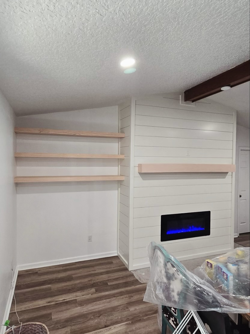 Modern entertainment center with electric fireplace by AVP Construction JAX — Jacksonville & St. John's County, FL